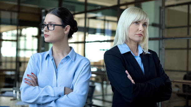 istock Competing women standing in office, colleagues in conflict, leadership challenge 1183304082