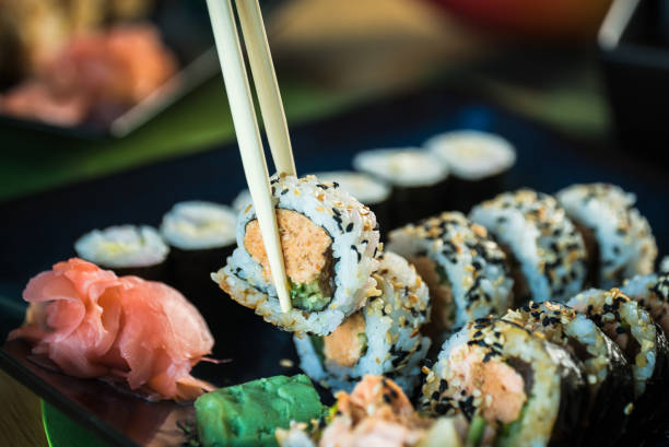 istock Sushi Set. Various rolls on a wooden plate. On dark rustic background 1183304713