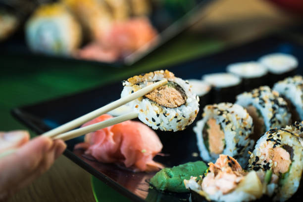 istock Sushi Set. Various rolls on a wooden plate. On dark rustic background 1183305483