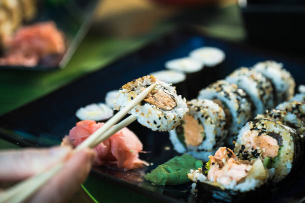 istock Sushi Set. Various rolls on a wooden plate. On dark rustic background 1183305592