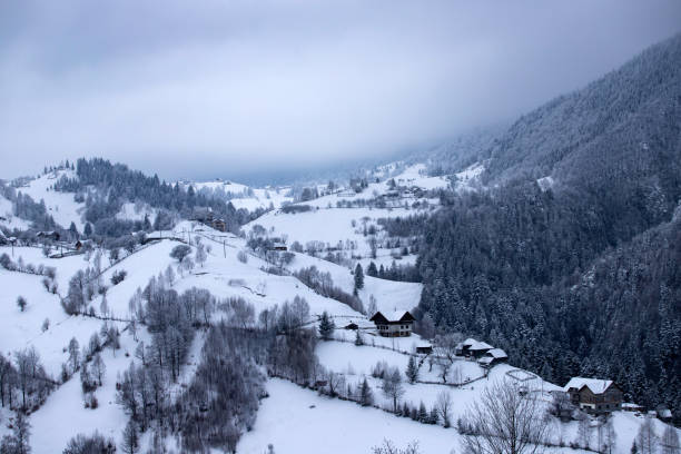 Winter landscape in the Carpathian Mountains. Snow covered small mountain village.