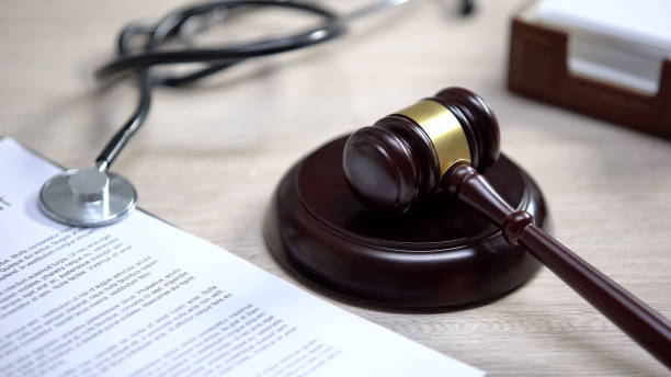 istock Stethoscope on table, gavel lying on sound block, injury compensation, crime 1183307602