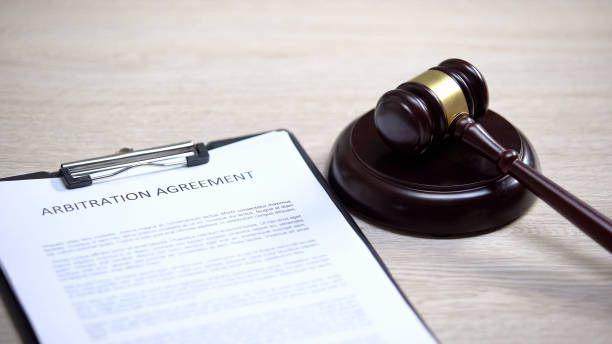 istock Arbitration agreement table, gavel lying on sound block, conflict settlement 1183307643