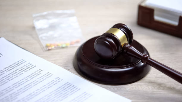 istock Drug pills on table, gavel lying on sound block, illegal medicine, judgment 1183307664