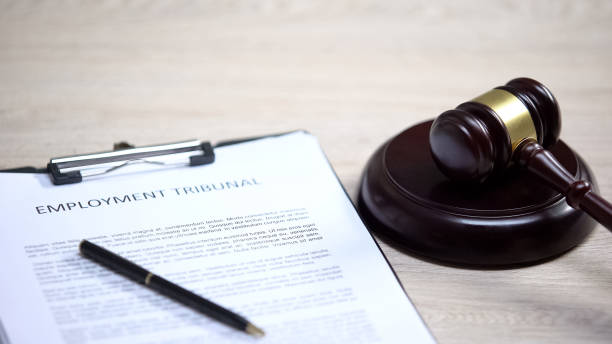 istock Employment tribunal document on table, gavel lying on sound block, dispute 1183307690