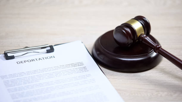 istock Deportation document on table, gavel lying on sound block, migration law 1183307734