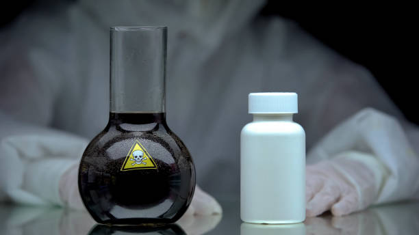 istock Poisonous liquid and jar antidote pills standing on table, scientific experiment 1183308077