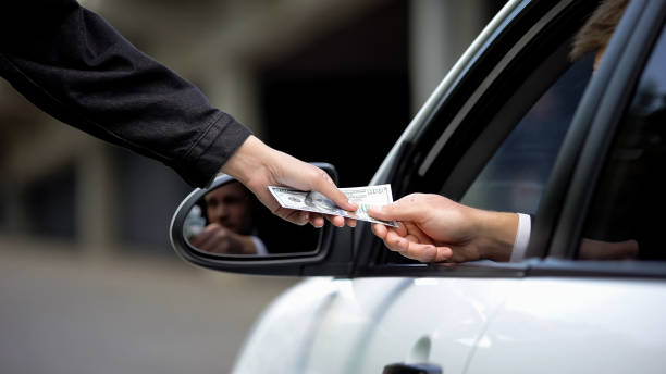 istock Female hand taking dollars from driver, parking payment, car rent service, order 1183308777