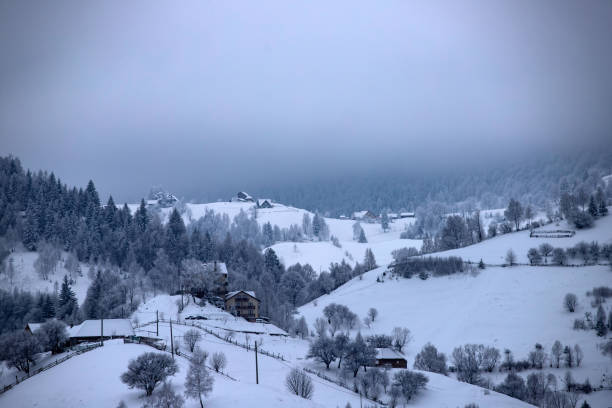 Winter landscape in the Carpathian Mountains. Snow covered small mountain village.