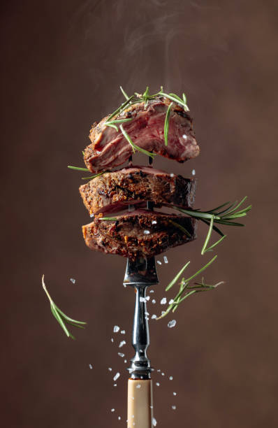 istock Grilled ribeye beef steak with rosemary on a brown background. 1183310049