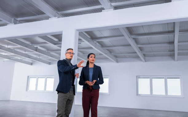 istock Business people discussing in unfurnished office 1183311589