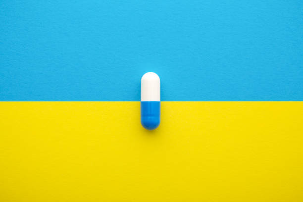 istock Medical pill on yellow blue background 1183312802
