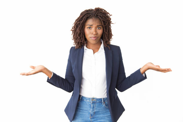 Upset puzzled businesswoman making do not know gesture Upset puzzled businesswoman making do not know gesture. Young black business woman standing isolated over white, looking at camera, shrugging. Clueless concept Confusion stock pictures, royalty-free photos & images