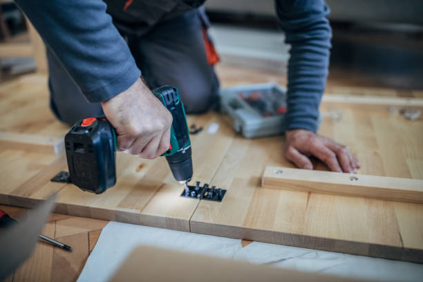 istock Man using drill on furniture 1183313824