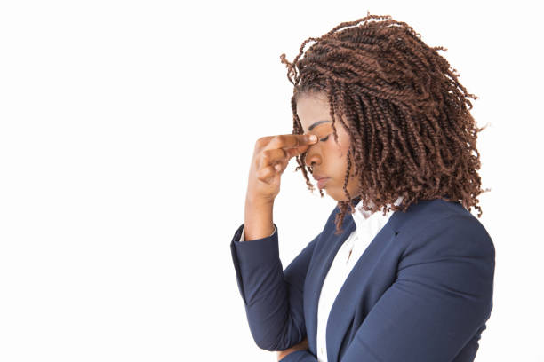 istock Tired female employee touching face with closed eyes 1183315297