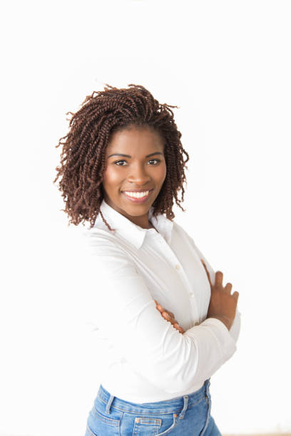 istock Cheerful sales agent standing with arms crossed 1183316589