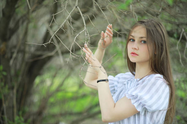 istock A girl in a spring green park 1183318454