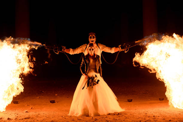 istock Halloween couple standing with flamethrower. big fire 1183318504