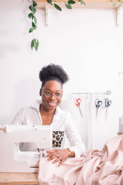 istock african seamstress sews clothes 1183318627