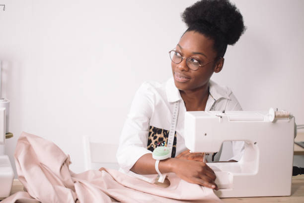 istock african seamstress sews clothes 1183320324