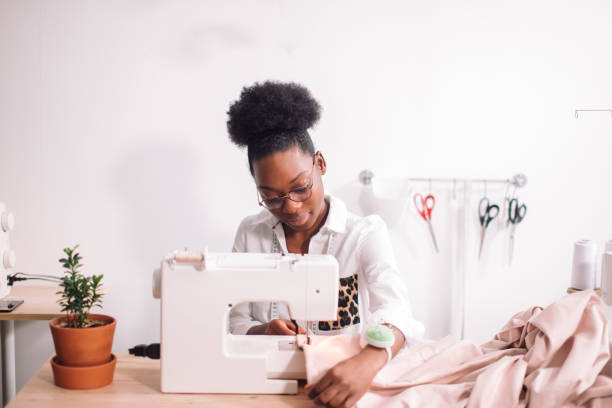 istock african seamstress sews clothes 1183320385