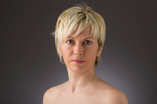 Portrait of pleased woman with short blond hair