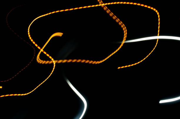 istock Black background with multicolored luminous lines 1183322165
