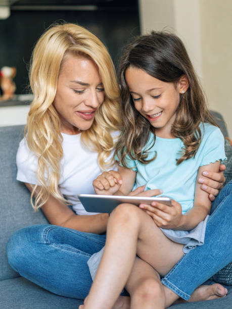 istock Mother and daughter looking at digital tablet 1183323471