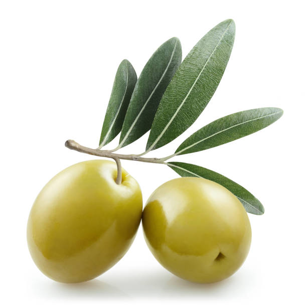 Olives on white Delicious green olives with leaves, isolated on white background olive fruit stock pictures, royalty-free photos & images