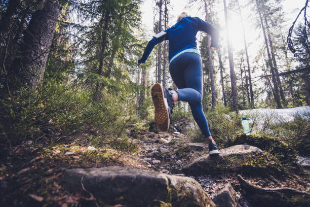 istock Woman trail runner running in forest. 1183323938