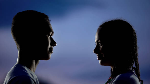 istock Smiling couple silhouettes looking each other, love from first sight, affection 1183324071