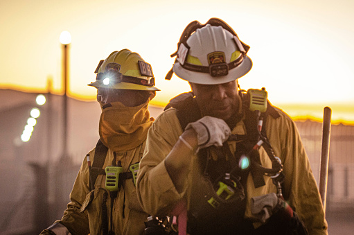 Richard Fields talks to another firefighter over a handheld transceiver during the Sepulveda Basin Fire on Thursday, Oct. 24, 2019, in Los Angeles, Calif. The fire started out earlier in the afternoon and has caused to burn 50 acres of land. (Photo by Kevin Lendio)