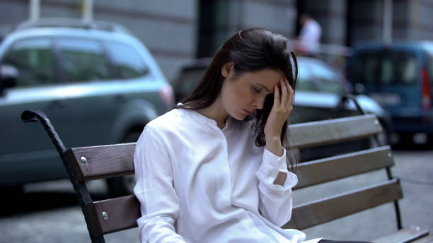 istock Tired lady sitting on bench, fighting with sleeping desire, overworking problem 1183325219