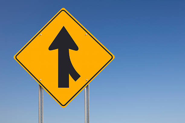 istock Merge Ahead Traffic Sign Post over Clear Blue Sky Background 118332528