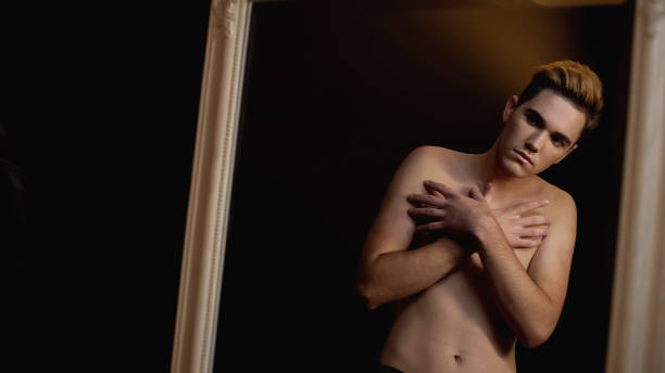 istock Shy man closing naked torso in front of mirror 1183326877