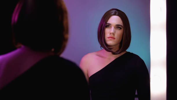 istock Sad travesty diva looking in mirror, thinking about surgery, gender dysphoria 1183326964