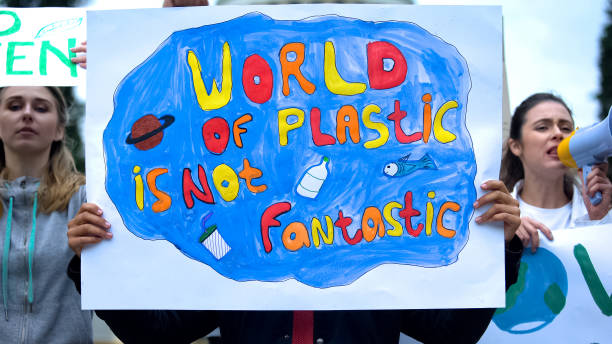 istock Crowd chanting environmental slogans, awareness about plastic pollution, ecology 1183326976