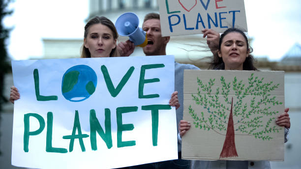 istock Young people chanting slogans about planet ecology, deforestation problems 1183327082