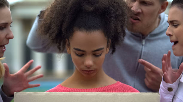 Afro-american girl suffering people screaming racial insults, bullying problem Afro-american girl suffering people screaming racial insults, bullying problem racism photos stock pictures, royalty-free photos & images