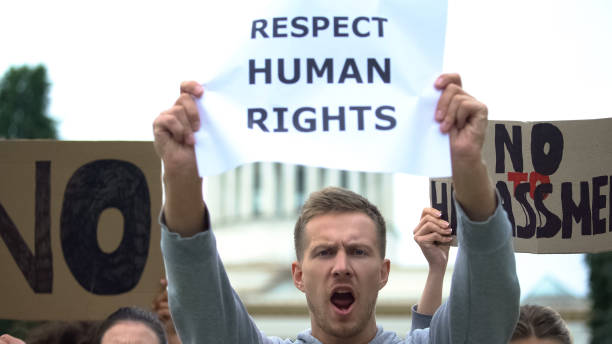 istock Crowd shouting slogan to respect human rights, no harassment, against violence 1183327240
