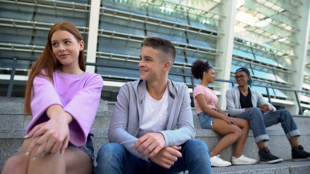 istock Students couples sitting outdoors flirting date, romantic relations, adolescence 1183327793