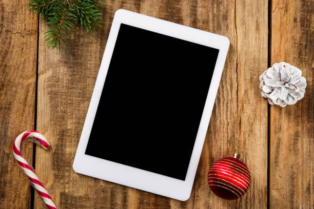 istock Mock up blank empty screen of tablet on wooden background 1183328319