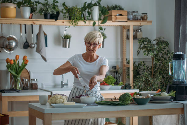 istock Woman Prepering Food at Kitchen 1183329304