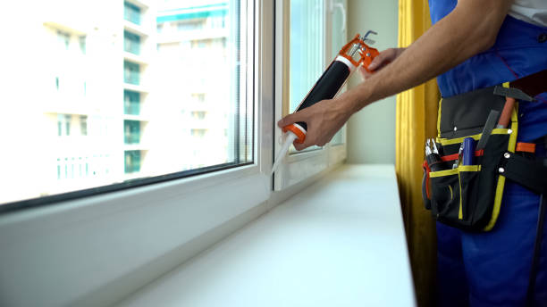 istock Foreman repairing window sealing frame to provide sound insulation, installation 1183329318