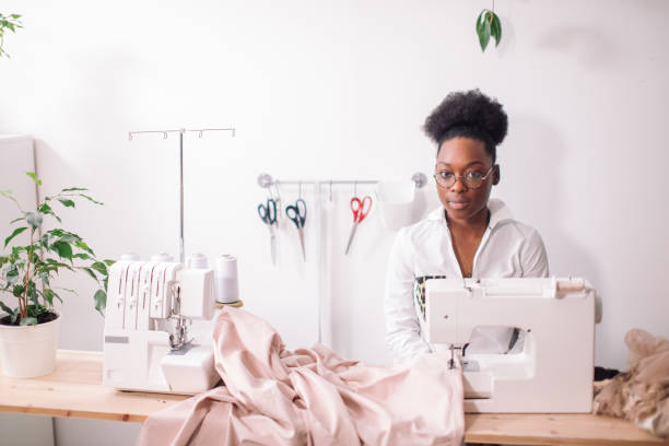 istock african seamstress sews clothes 1183329377