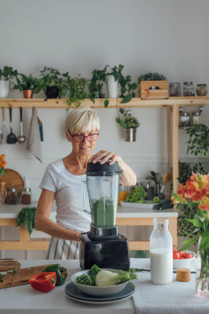 istock Senior Woman Using Blender at Kitchen 1183329394