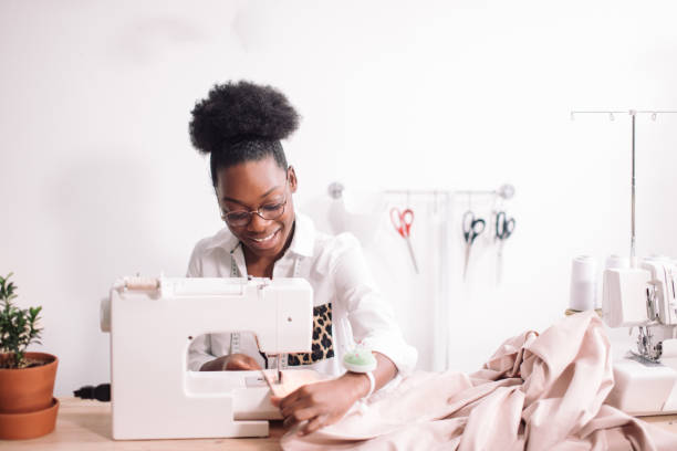 istock african seamstress sews clothes 1183329440