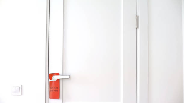 istock Do not disturb sign hanging on doorknob, no knocks or enters, private territory 1183329515