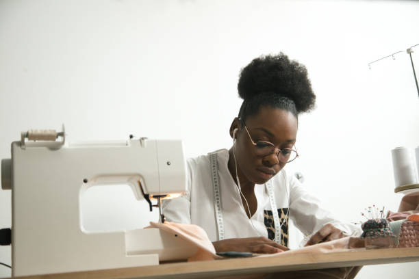 istock sewing fabric with needle at seamstress workplace 1183329721
