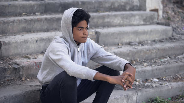 istock Pensive american millennial sitting alone thinking of problem, disappointment 1183330298